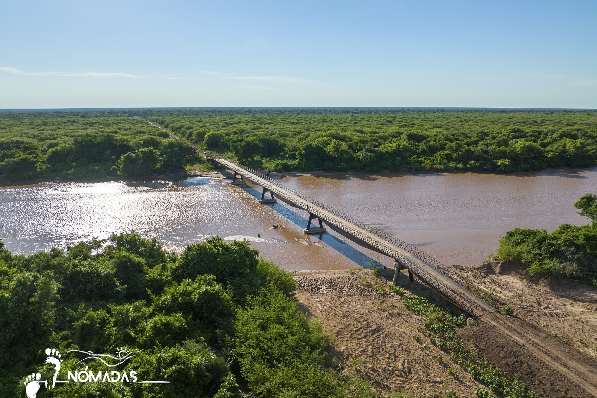 Más de 200 familias de menonitas compraron 14.400 hectáreas de bosque en los Bañados de Isoso que colindan con el área protegida nacional. Para deforestarlas, construyeron en silencio, sin autorización del Gobierno ni estudio sobre el impacto ambiental, un puente de 150 metros de largo sobre el río Parapetí, que les costó medio millón de dólares. Ya metieron 15 orugas y deforestaron 3.000 hectáreas.